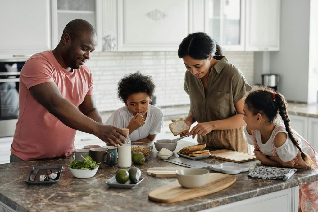 The family is cooking together in the kitchen
